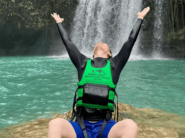 教室で笑顔の学生二人がピースサインをしながらホワイトボードの前でポーズを取っている